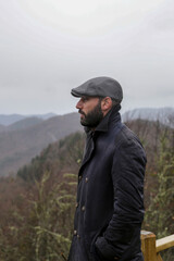 Young handsome man outdoors in fall clothing with autumn natural surroundings 