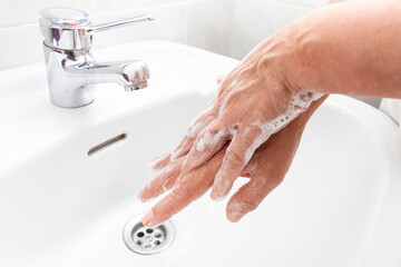 Woman washing her hands and disinfecting them for Coronavirus disease
