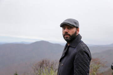 Young handsome man outdoors in fall clothing with autumn natural surroundings 