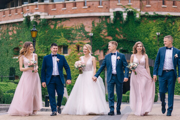 Groomsmen and bridesmaids walking on wedding ceremony