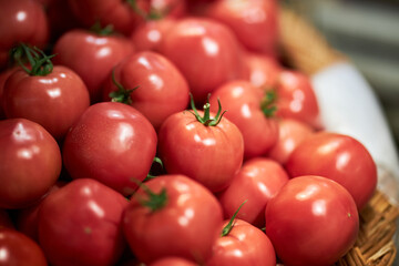 Ripe tomatoes at the grocery store. Vegetables are on the shelf in the grocery store. Cherry tomatoes at the farmers' market.