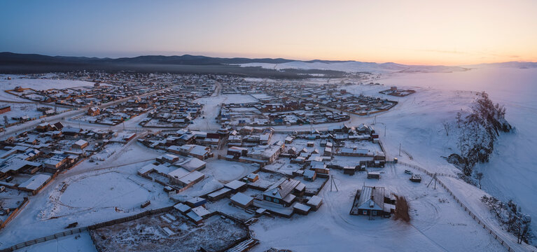 Baikal frozen towns from aerial view at sunset in panoramic view