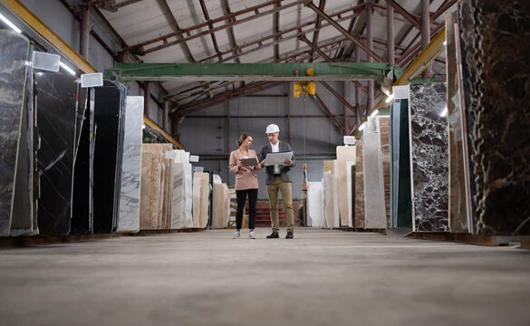 Adult workers in marble warehouse