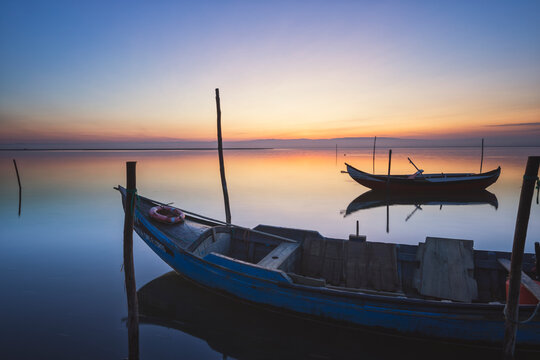 Wooden Boats at sunset with the sea in calm