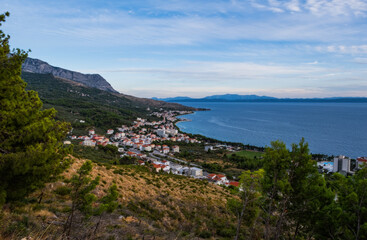 The Makarska Riviera is a part of the Croatian coast of the Adriatic Sea. Top view on Tucepi at sunset time. September 2020