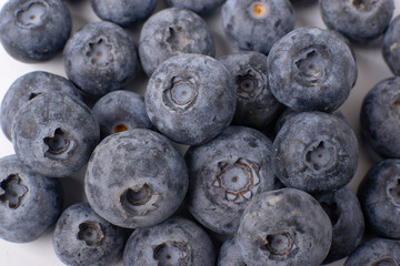 Berry background. Fresh berry blueberries on a white background. Concept of healthy and diet food. Flat lay, top view, Ripe blueberries with copy space for text, shallow DOF