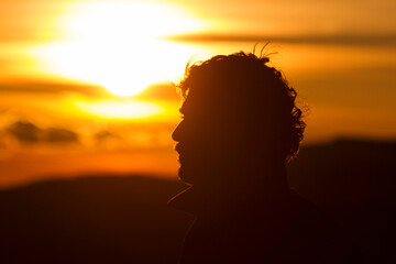 Silhouette of a man's head at sunset