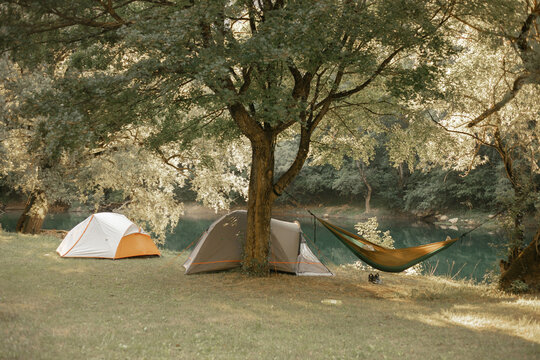 Hammock and tents by the river