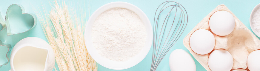 Ingredients for baking on light blue background.