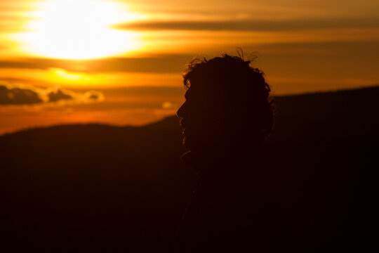 Silhouette of a man's head at sunset