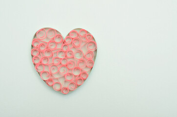 A paper heart on light blue background