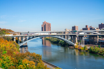 Fototapeta na wymiar New York / USA - November 7 2020: The High Bridge with highway and colored trees during autumn season