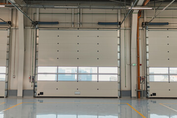 Garage rolling door in a new car workshop with resin floor.