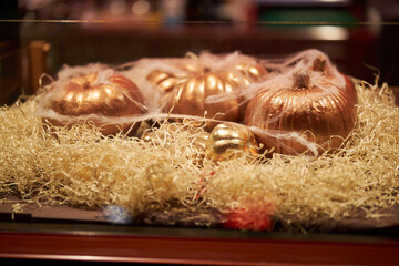 Painted pumpkin. Decorated Pumpkin in gold color. Halloween celebration concept. Pumpkin. Pumpkin decorations.