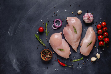 Raw chicken fillet with spices and herbs.