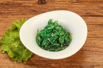 Green Chuka Seaweed Salad Isolated on White Background Top View. Wakame Sea Kelp Salat