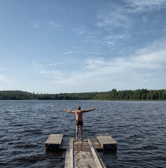 Fototapeta na wymiar wooden footbridge on a lake in Finland.