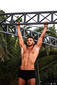 A young athlete doing back exercises outdoors