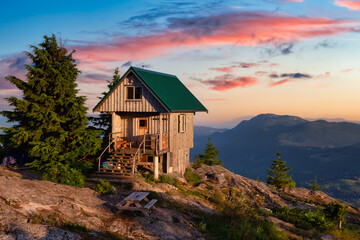 View of Tin Hat Cabin on top of a mountain. Dramatic Colorful Sunset Art Render. Located near Powell River, Sunshine Coast, British Columbia, Canada.