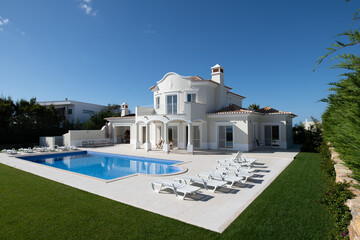 Exterior of luxury Holiday Villa with blue sky and beautiful swimming pool