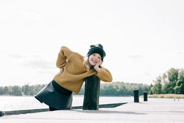 portrait of a young girl playing at the beach looking cheeky posing