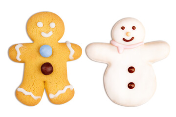 Delicious Christmas cookies in the shape of a gingerbread doll and a snowman decorated with icing sugar, fondant and candies isolated on white background