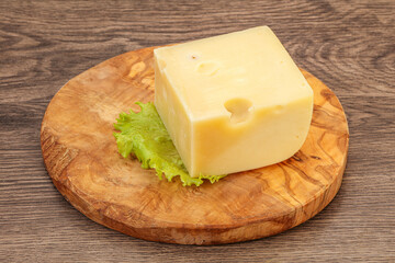 Emmental cheese over wooden board