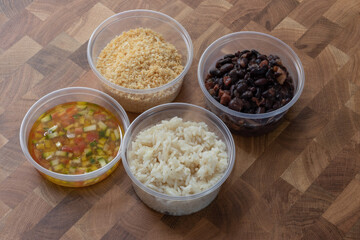 Food take away Brazilian traditional Rice and Black beans, vinagrette and farofa 