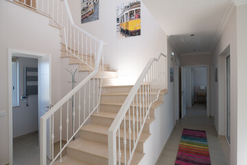 Staircase with metal railings in a home with ceramic tiled floors