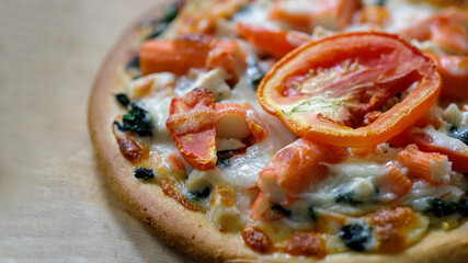 Homemade pizza and tomato topping. isolated on wood background.