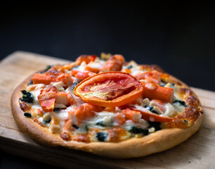 Homemade pizza and tomato topping. isolated on dark background