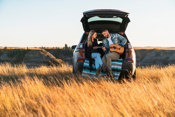Couple Playing Guitar Together in the Country