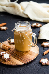 Pumpkin spiced latte or coffee in a cup on turquoise vintage background. Autumn, fall, or winter hot drink. Cozy breakfast or snack.