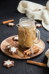 Pumpkin spiced latte or coffee in a cup on turquoise vintage background. Autumn, fall, or winter hot drink. Cozy breakfast or snack.