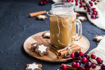 Pumpkin spiced latte or coffee in a cup on turquoise vintage background. Autumn, fall, or winter hot drink. Cozy breakfast or snack.