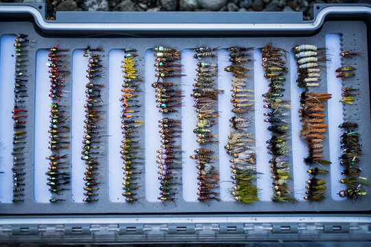Full tackle box of fly fishing flies in Washington river