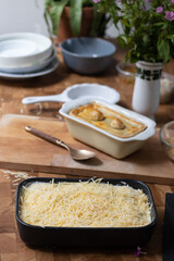 Tart or savory pie in a white dish at wooden table