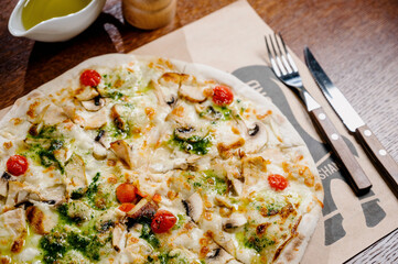 pizza with chicken, mozzarella, olives and basil top view with copy space