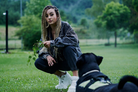 Young woman with blonde colored braided hair wearing a denim jac