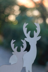 Two deer figures, minimal Christmas decoration. Selective focus, beautiful bokeh. 