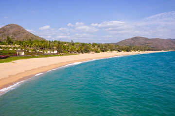 Beautiful background of empty sandy beach and calm turquoise sea on paradise tropical island