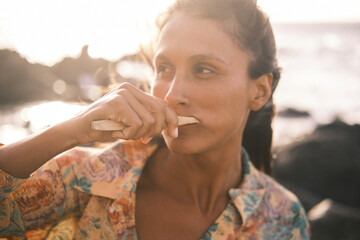 Portrait of beautiful woman brushing her teeth with bamboo toothbrush