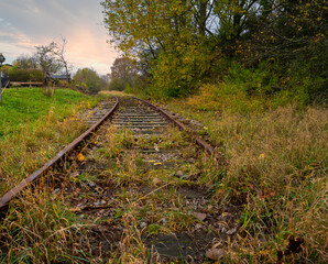 Railroad tracks with a dramatic sunset in the background. Picture from Scania county, Sweden