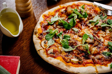 Mushroom pizza with addition mozzarella cheese and herbs on a wooden table, top view