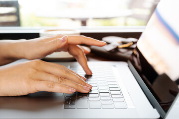 woman hands typing on laptop keyboard. Woman working at office w