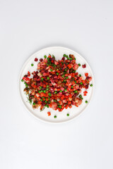 dish of traditional Russian cuisine to vinigret Russian salad on a white plate