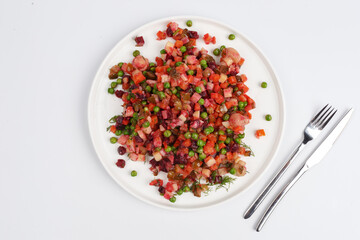 dish of traditional Russian cuisine to vinigret Russian salad on a white plate