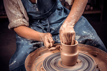 Master class on modeling of clay on a potter's wheel In the pottery workshop