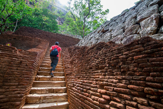 woman climbing up the stairs towards the rock fortress of Sigiriya