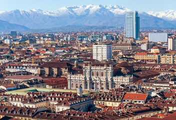 Aerial view of the city of Turin with the background of the Alps covered by snow taken from the top of Mole Antonelliana